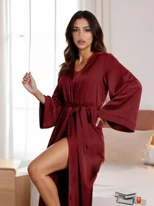 Detailed texture of burgundy satin long-sleeve robe with silk-like finish and waist tie