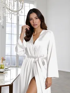 Detailed view of elegant white satin long-sleeved bathrobe with matching waist tie