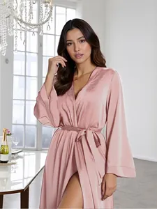 Close-up of pink velvet robe with satin sheen, flared sleeves, and elegant tie-waist detail
