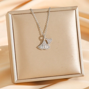 Elegant ginkgo leaf necklace with sparkling cubic zirconia on a luxury jewelry box