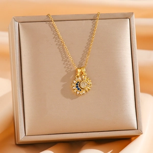 Macro detail of gold sun and moon pendant with micro-set blue and white zircons