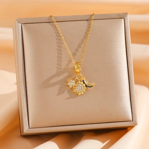 Detail of gold celestial pendant featuring sun star and moon motifs with blue gems