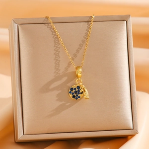 Elegant gold titanium steel necklace featuring a deep blue zircon pendant on silk