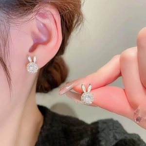 Charming rabbit stud earrings with gold plating and zircons worn on ear for women