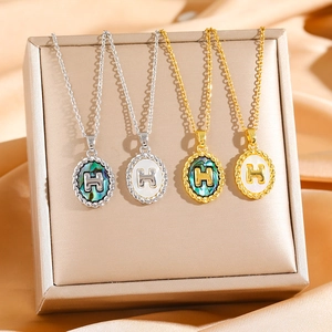 Letter H shell pendant necklace in gold and silver stainless steel finishes
