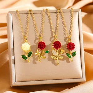 Luxurious gold rose necklaces with red flocking and crystal accents on champagne satin