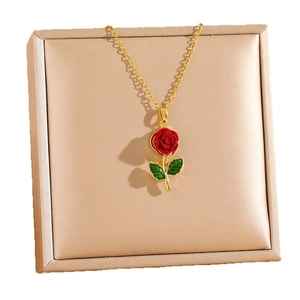 Luxurious titanium steel necklace featuring a red rose pendant with green leaves on gold chain