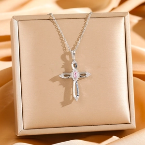 Hollow cross necklace with pink marquise zircon and silver plating on silk background