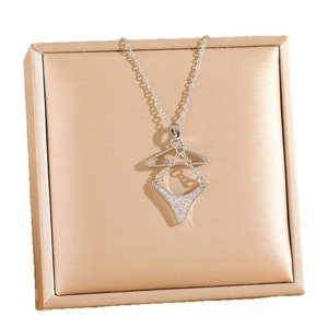 Creative stainless steel necklace with zircon-studded bra pendant on satin background