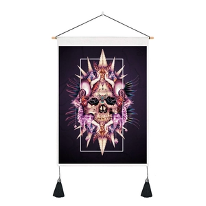 Detail of skull art tapestry with shells, wooden rod, and black tassels on canvas