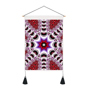 Detail of mandala wall tapestry with red and black geometric pattern and black tassels
