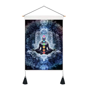 Detail of bohemian tapestry featuring seven chakras, hamsa hand, and wooden hanging frame