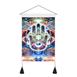 Detail of bohemian Hamsa Hand tapestry with mandala patterns and black tassels on wood