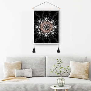 Abstract mandala tapestry with black gold fractal design, wooden pole, and hanging tassels