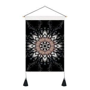 Macro detail of mandala wall tapestry featuring wood pole, black rope, and twin tassels
