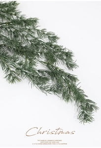 Close-up of realistic dark green PE pine needle branch for Christmas floral arrangements