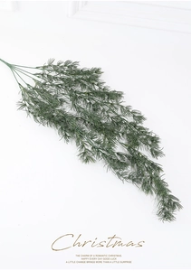 Close-up of lifelike artificial dark green pine needles for Christmas wreath decoration