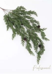 Detailed view of realistic artificial pine branch with green needles and mini pine cones