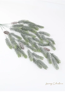 Detailed view of artificial pine branch with pine cones and white frosted snow decor