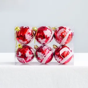 Detail view of 6cm red Christmas ornaments with white glitter snowy scene patterns