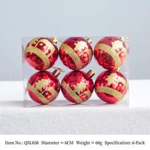 Detail of red Christmas ornaments featuring gold glitter snowy house and forest patterns