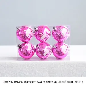 Detail of 6cm pink Christmas balls with white house prints in transparent box