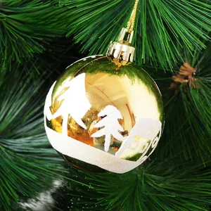 Close-up of golden Christmas ball with white flocked snow scene and hanging string