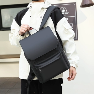 Detail of black geometric triangle pattern backpack with flap closure and zipper pocket