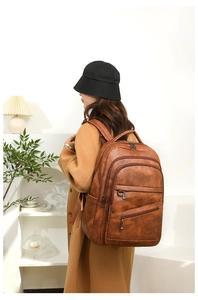 Sac à dos vintage marron en cuir PU avec plusieurs poches zippées et un design minimaliste