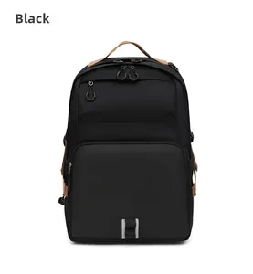 Front detail of black waterproof commuter backpack with brown leather handle