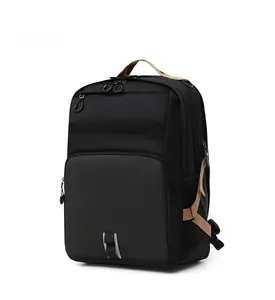 Detailed side view of black commuter backpack with khaki straps and reflective safety strip
