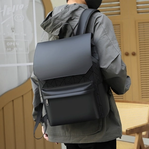 Man wearing black geometric pattern backpack outdoors with matte leather details