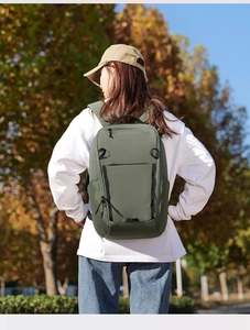 Outdoor view of a green waterproof nylon backpack with wide straps for comfort and durability