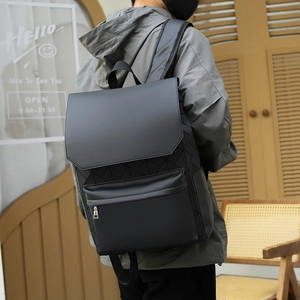 Detail view of black geometric backpack with 3D triangle pattern and matte finish