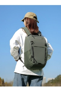 Macro shot of durable olive green travel backpack with mesh side pockets and zippers
