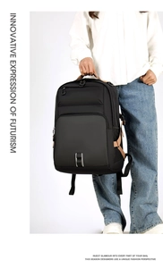 Detailed close-up of a large black business backpack featuring brown zipper pulls and straps