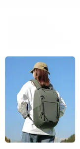 Detailed view of lightweight dark green tactical nylon backpack with multiple zipper pockets