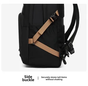 Detail of the side buckle and breathable mesh pocket on a black commuter backpack