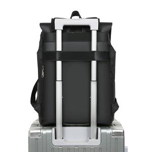 Detail of travel backpack with luggage strap fixed on silver metal suitcase handle