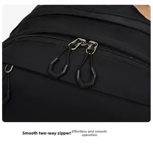 Close-up of smooth two-way zippers with ergonomic pulls on a durable black backpack