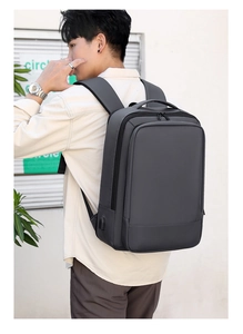 Detalle de mochila gris expandible con puerto USB y correas ergonómicas en forma de S