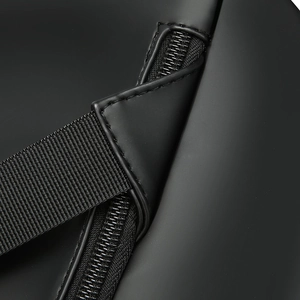 Close-up of matte finish material and reinforced stitching on men's travel backpack