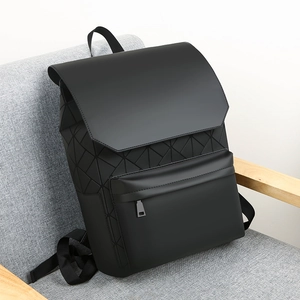 Detailed view of black geometric matte backpack with triangular mosaic design on chair