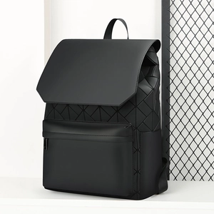 Detail of black backpack showing geometric triangle pattern and matte synthetic finish