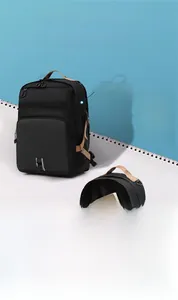 Detail of black 24.5L backpack with dual compartments and brown handles for storage
