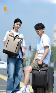 Outdoor lifestyle shot showing the roll-top design and large capacity of the travel backpack