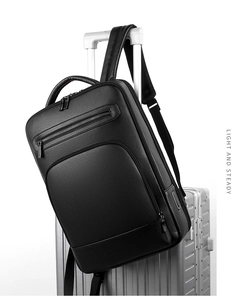 Detail of black leather business backpack mounted on luggage handle with LIGHT AND STEADY text
