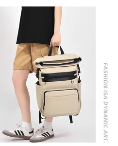 Detail of beige roll-top thermal backpack with black straps and waterproof material