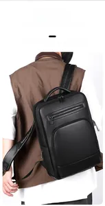Rear view of man wearing a black pebble grain leather business laptop backpack with wide straps