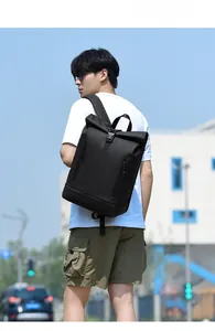 Outdoor shot of a black roll-top laptop backpack with waterproof vertical zippers